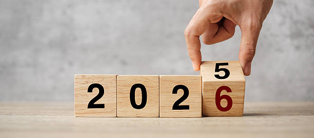 istock hand flipping block 2025 to 2026  text on table. Resolution, strategy, plan, goal, motivation, reboot, business and New Year holiday concepts 2229496660
