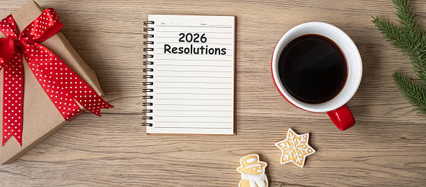 istock 2026 Resolutions with notebook, black coffee cup, Christmas cookies and pen on wood table, Top view and copy space. Xmas, Happy New Year, Goals, To do list, Strategy and Plan concept 2229496894
