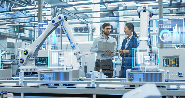 istock Electronics Factory Assembly Line Digitalization: Automated Robot Arms Manufacturing Advanced Equipment. Managers Discussing Work while Futuristic AI Computer Vision Analyzing, Scanning Conveyor Line 2229498837