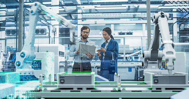 istock Electronics Factory Assembly Line Digitalization: Automated Robot Arms Manufacturing Advanced Equipment. Managers Discussing Work while Futuristic AI Computer Vision Analyzing, Scanning Conveyor Line 2229498953