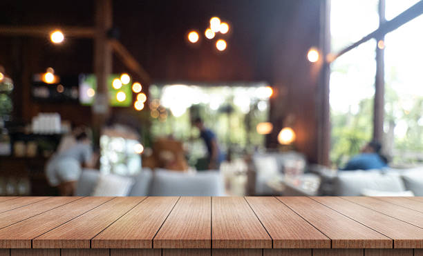 istock Empty wooden table top with lights bokeh on blur restaurant background 2229499768