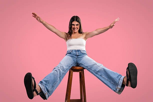 istock Young woman expressing joyful energy in studio portrait 2229501162