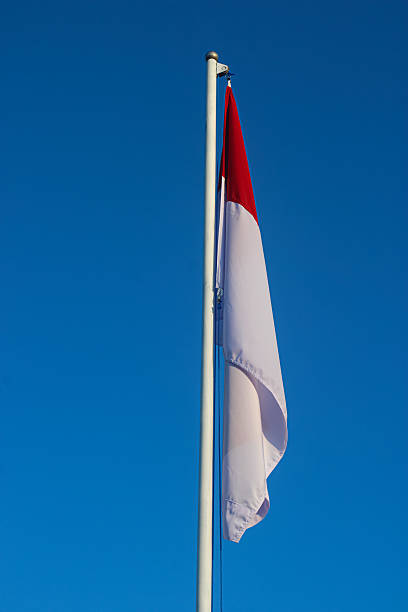 istock Majestic Indonesian Flag Against Clear Blue Sky 2229501714