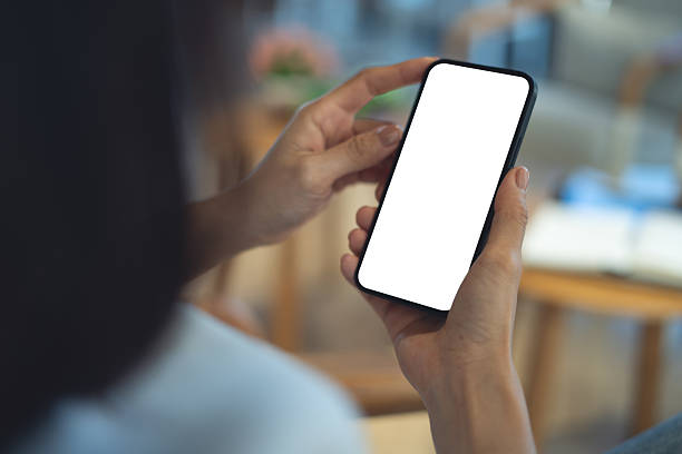 istock Mockup blank white screen mobile phone. Woman hand holding, using smartphone at coffee shop, template for mobile app design, social media marketing, close up 2229501973