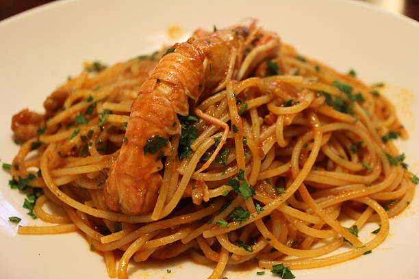 istock Italian cuisine: spaghetti alla busara (spaghetti with scampi and tomato sauce) in Venice, Italy 2229502269