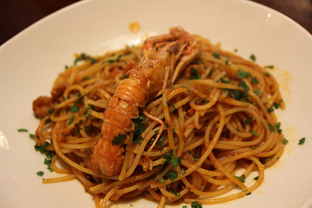 istock Italian cuisine: spaghetti alla busara (spaghetti with scampi and tomato sauce) in Venice, Italy 2229502293