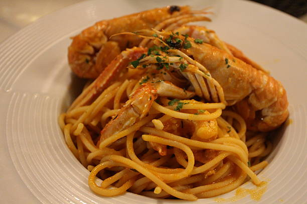 istock Italian cuisine: spaghetti alla busara (spaghetti with scampi and tomato sauce) in Venice, Italy 2229502620