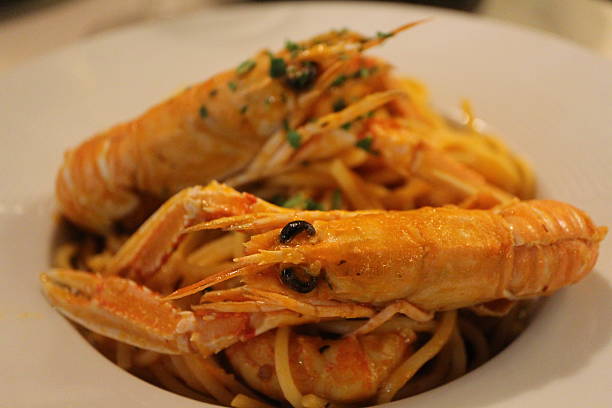 istock Italian cuisine: spaghetti alla busara (spaghetti with scampi and tomato sauce) in Venice, Italy 2229502648