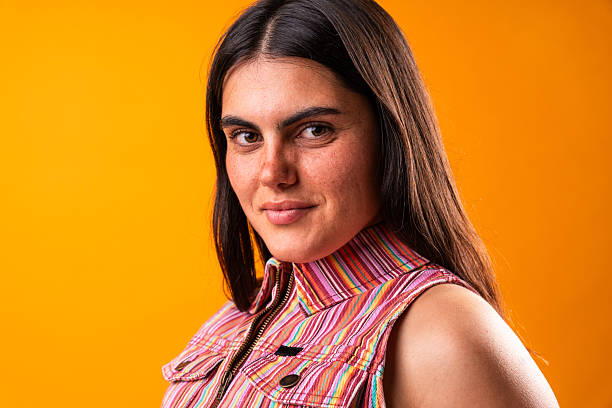 Confident young woman showcasing unique style in studio