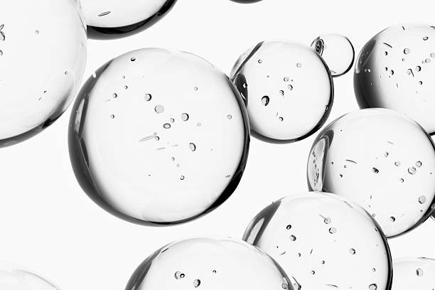 Abstract 3d liquid, water drops, molecules with bubbles on gray background. Concept of cosmetics, science, and medicine. Pattern, template for products, designs, place for text.