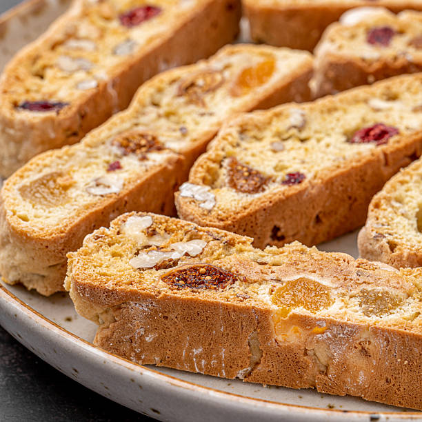 istock Italian Almond Biscotti biscuits in a rustic home made pottery bowl. Studded with almonds and cranberries, these twice-baked treats are aromatic and inviting. Ideal. 2229512466