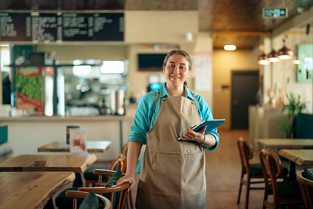 istock Smiling Restaurant Owner Holding Digital Tablet in Dining Area 2229514514