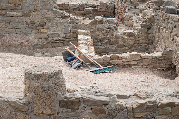 Tools resting on the ground at an archaeological dig site, uncovering ancient ruins