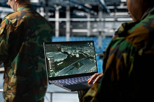 istock Close up of military technician tracking satellite coordinates using laptop 2229515618