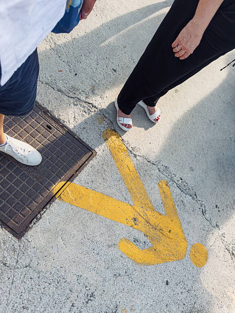 istock Yellow walking man icon on pavement indicating pedestrian flow in public space 2229520000
