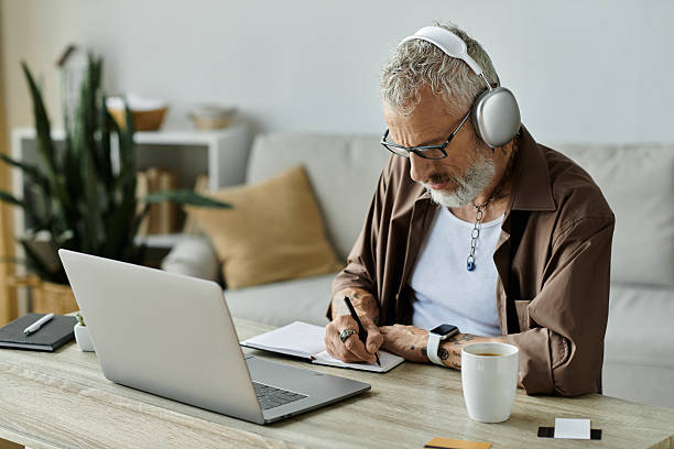 Engaging senior man captures ideas while working on his laptop in a cozy home office
