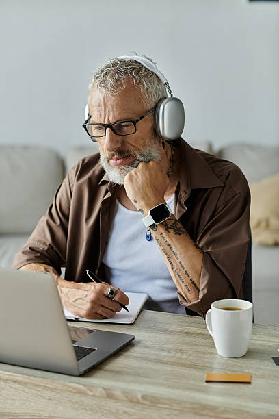 istock Engaged senior man enjoying online learning at home with a cup of coffee 2229521086