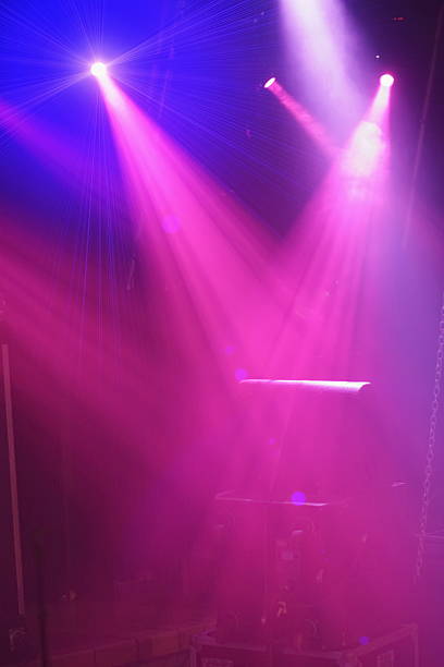 istock Pink light show with two pink lights shining on a dark background 2229523086