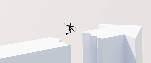 A businessman jumping over a gap in an arrowhead. Courage, challenge concept.