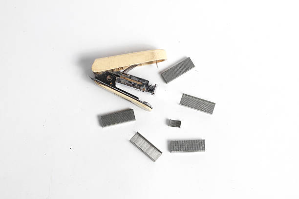 Top view of Stapler and hole punch on checkered paper,concept of education.
