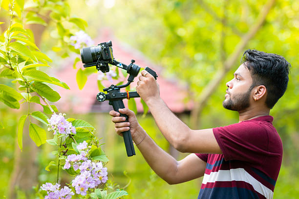 istock Videographer exploring nature and filming with camera and stabilizer gimbal in nature. 2229526299