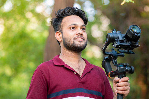 istock Videographer exploring nature and filming with camera and stabilizer gimbal in nature. 2229526301