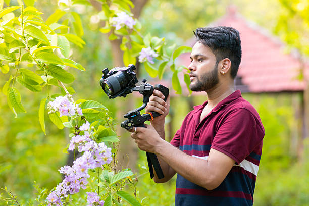 istock Videographer exploring nature and filming with camera and stabilizer gimbal in nature. 2229526303