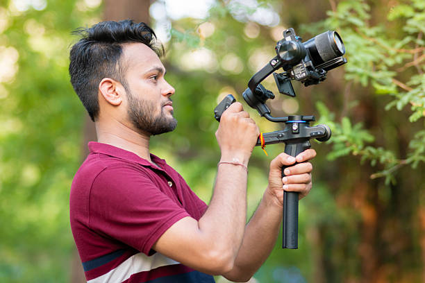 istock Videographer exploring nature and filming with camera and stabilizer gimbal in nature. 2229526306