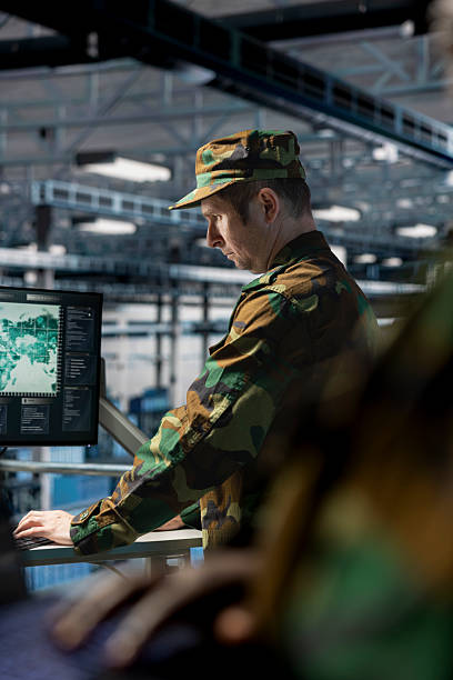 istock Soldier in server hub checking reports data operations workstation monitor 2229528356