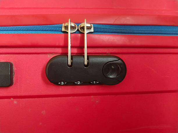 istock Close-up of a red travel suitcase with dual zippers secured using a combination number lock, symbolizing luggage security, travel safety, and personal belongings protection 2229529547