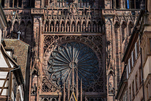 Gothic rose window of the Strasbourg Cathedral de Notre-Dame with statues of twelve apostles above in city of Strasbourg, Alsace, France.