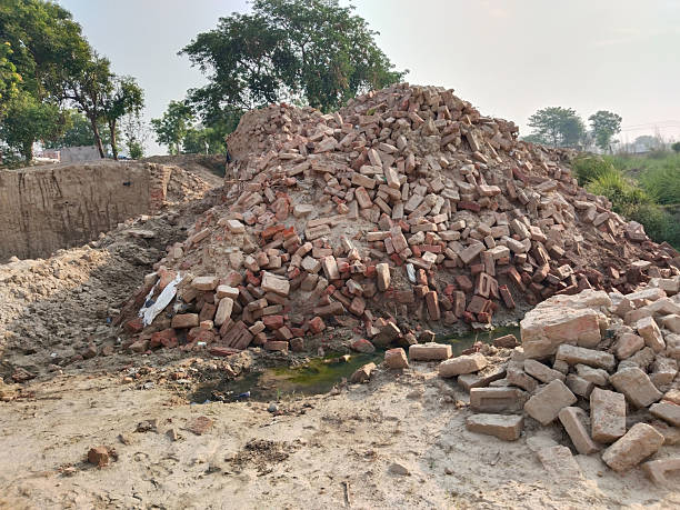 istock Completely demolished small brick and concrete bridge over dry stream, showing exposed debris and broken structure, prepared for reconstruction in rural area or semi-urban landscape 2229530839