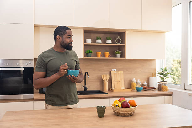 istock Young happy freshly divorced or recently single man after toxic relationship breakup standing at kitchen in new apartment he rent eating breakfast and enjoying new beginnings and morning silence 2229532384