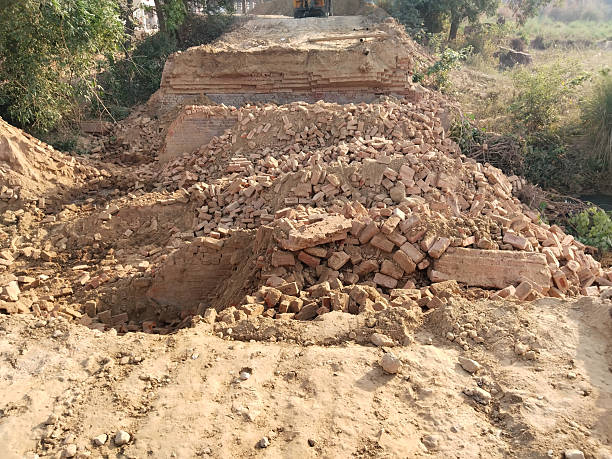 istock Demolished Old Bridge with Scattered Bricks and Earth Preparing for New Construction Reflecting Rural Development and Modern Engineering Under Open Sky with Vegetation and Future Infrastructure Plans 2229533641