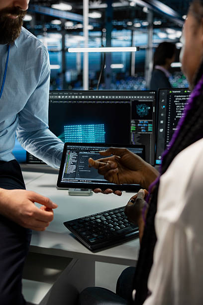 istock Close up of computer scientists coding on tablet in data center, updating AI 2229534300