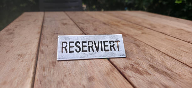A reserved sign placed on a wooden table, showcasing natural textures and colors, creating an inviting atmosphere for dining or gatherings.