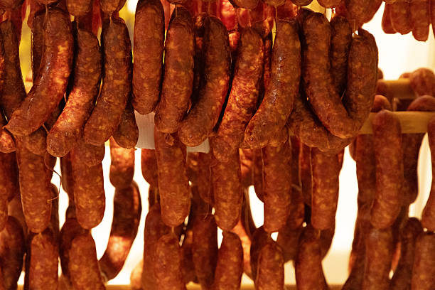 istock Hanging sausages drying in a warm environment with rich textures and appetizing colors 2229536061