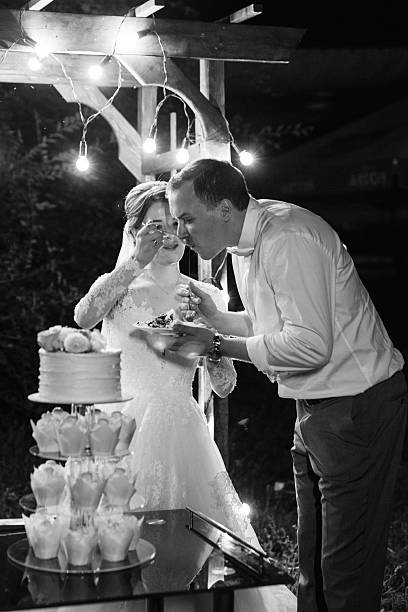istock newlyweds happily cut and taste the wedding cake 2229536203