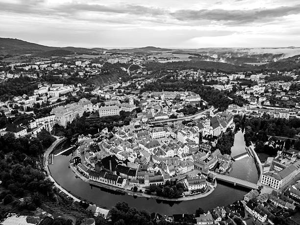 A breathtaking sunrise casts warm light over the historic town of Cesky Krumlov, highlighting its unique architecture and the meandering Vltava River.