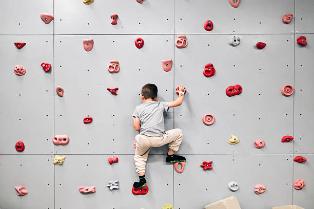 istock Kid Focused on Indoor Rock Climbing Challenge 2229537747