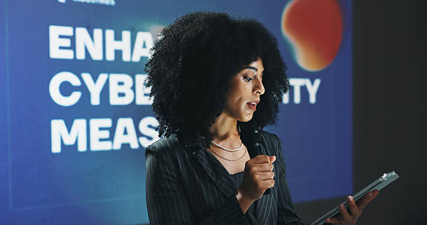 istock Business woman, presentation or seminar with tablet or mic for speech or cybersecurity convention. Female person, employee or speaker with technology for online safety measures or tradeshow at summit 2229538276