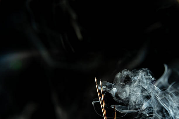 istock Dancing incense smoke with light in the dark. 2229538920