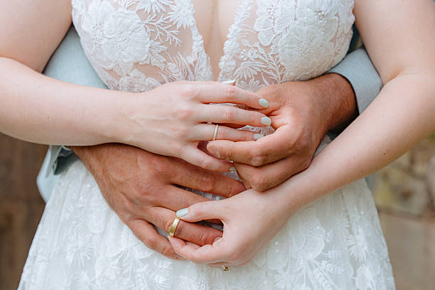 istock Hands Embrace in Wedding Dress Close-Up 2229540025