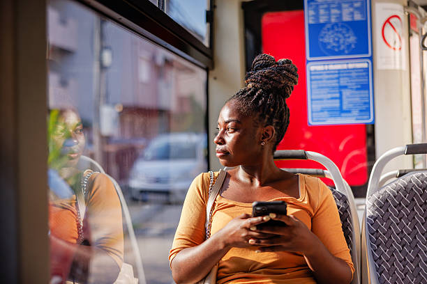 istock Female Passenger Browsing Mobile on City Bus Ride 2229540555