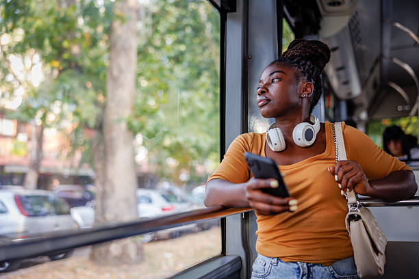 istock Woman Looking Through Window While Traveling Through City 2229540925