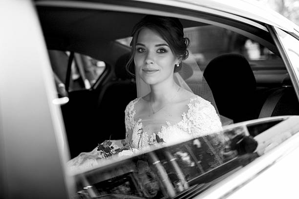 istock bride and groom with a black car 2229541273