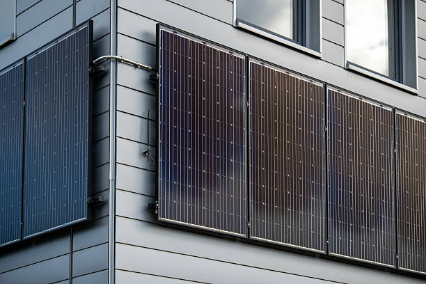 istock Modern Building Exterior With Solar Panels Mounted On Grey Siding Wall: Sustainable Energy Technology, Clean Power Source, Photovoltaic Cells, Environmental Friendly Design Under Natural Daylight 2229541789