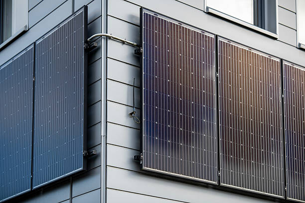 istock Modern Building Exterior With Solar Panels Mounted On Grey Siding Wall: Sustainable Energy Technology, Clean Power Source, Photovoltaic Cells, Environmental Friendly Design Under Natural Daylight 2229541932