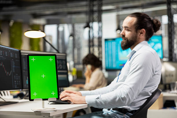 istock Finance analyst working on stock trade progress with green screen 2229543693