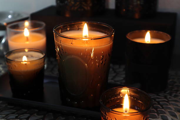 luxury lighting aroma scented candle on nice table in bedroom for creating good relax ambient on Valentine day with beautiful background room , candle making process natural soy wax candles , design glass tealight candle